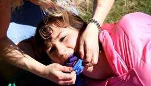 Julia tied and gagged in a shiny nylon skisuit