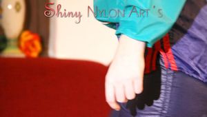 Mara wearing a sexy shiny nylon shorts over a rain pants and a rain jacket during her workout infront of the TV (Pics)