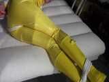 Watch Pia enjoying Bondage in her shiny nylon yellow Rainwear