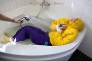 Julia tied and gagged in a ski suit in the bath tub