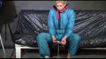 Pia ties and gagges herself with cuffs wearing a sexy green shiny nylon down suit (Video)