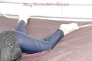 Shelly tied and gagged on a bed with downjacket and shiny rainsuit