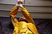 Pia tied and gagged in a shiny nylon rainsuit 