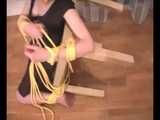Alice Lee - Dress-wearing beauty gets tied to a table and escapes (video)