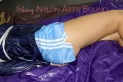 Samantha tied and gagged wearing a beautiful lightblue nylon shorts and a darkblue rain jacket (Pics)