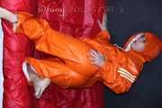 Watching Pia putting on a wonderful supersexy shiny nylon rainssuit in orange (Pics)