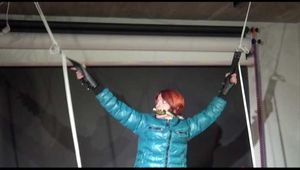 Sonja wearing a sexy white shiny nylon skirt and a green shiny nylon down jacket being tied and gagged with ropes (Video)