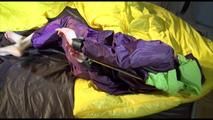 Lucy tied, gagged and hooded on bed on a bar wearing sexy purple rainwear (Video)