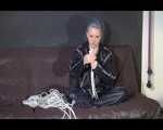 Watching Mara wearing sexy black rainwear during sorting her ropes for the next bondage session (Video)