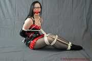 Bound in sexy PVC minidress and PVC gloves