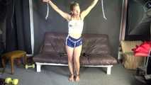 Watching sexy Sandra wearing an darkblue shiny nylon shorts and a white adidas top being tied and gagged overhead with ropes, chaines and a ballgag (Video)