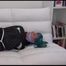Mara tied and gagged on a white sofa in a reading lounge wearing a sexy purple shorts with shadow stripes and a black rain jacket (Video)