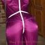 Katharina tied and gagged in a shiny nylon rainsuit