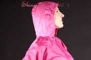 Mara wearing a sexy pink rainsuit posing infront of the camera in a studio (Pics)
