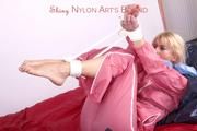 Pia tied and gagged in a beautiful rose shiny nylon rainsuit in bed (Pics)