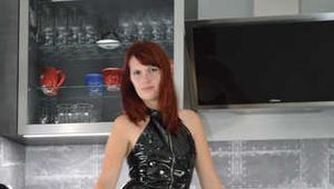 Our new Model in Miss Petra in shiny PVC and K-Way rainjacket first time in bondage