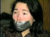 25 YEAR OLD ASIAN MAI-LING IS MOUTH STUFFED, CLEAVE GAGGED, HANDGAGGED, OTM GAGGED, TAPE GAGGED & TIGHTLY TIED TO A CHAIR  (D47-15)
