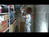 a video with Nicole tied and gagged in a shiny silver PVC sauna suit