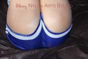 Watching sexy Pia wearing a supersexy blue shiny nylon shorts and a top being tied and gaggedoverhead with ropes and a clothgag (Pics)
