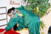 Lucy putting on linen on bed wearing supersexy green shiny nylon rainwear (Pics)