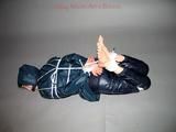 One of our archive girls tied and gagged in shiny nylon rainwear