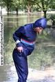 Stella bound outdoor in a blue rainsuit