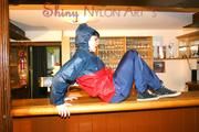 Jill posing in a bar wearing ONLY a sexy rainwear combination (Pics)