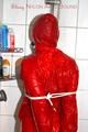 Stella tied and gagged under the shower wearing a shiny red nylon shorts and rain jacket (Pics)