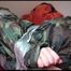 Mara taped, gagged and hooded on bed wearing a sexy shiny camouflage rainwear (Video)
