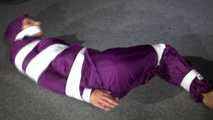 Sexy Sandra wearing a supersexy purple shiny nylon rainsuit bein tied and gagged and hooded on the floor with tape (Video)