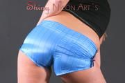 Beautiful archive girl posing in a photostudio wearing a supersexy shiny nylon shorts and a top (Pics)