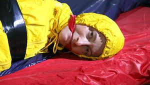 Sonja tied with tape and gagged with a ball gag on the bed wearing an oldschool yellow rainsuit (Pics)