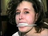 24 YEAR OLD ERICA IS MOUTH STUFFED, CLEAVE GAGGED, ROPE GAGGED & BALL-TIED WITH BLACK ELECTRICAL TAPE ON THE FLOOR (D51-16)