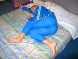 Katharina lolling on the bed wearing lightblue sexy shiny nylon rainwear (Pics)