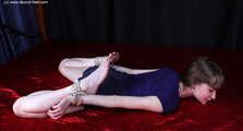 Agnes hogtied on bed
