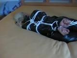 a video with one of our archive girls bound and gagged in a shiny black PVC sauna suit