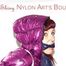 Mara tied and gagged on bed wearing a shiny purple down jacket and a blue rain pants (Pics)