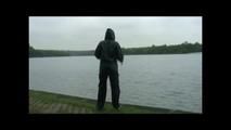 Sexy archive girl wearing shiny nylon shorts and puts on a rain pants and jacket (Video)