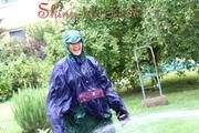 Jill Diamond in the garden playing with water out of the garden hose wearing supersexy shiny nylon rainwear and a rain cape (Pics)