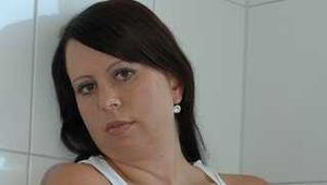 Benita taking a hot shower in a white undershirt and stockings
