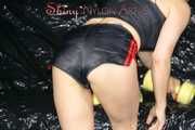 SEXY SANDRA wearing a black/red shiny nylon shorts and a black top during her workout with barbells (Pics)