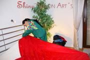 Lucy putting on linen on bed wearing supersexy green shiny nylon rainwear (Pics)