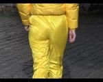 Jill wearing a yellow rain pants down jacket combination and rubber boots at home and outdoor (Video)