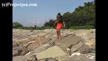016169 Eve Takes A Discrete Pee On The Rocks