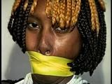 21 Yr OLD BLACK COLLEGE STUDENT GETS MOUTH STUFFED, WRAP TAPE GAGGED WHILE TIED TO A CHAIR  WEARING BLACK LINGERIE, GARTER BELT & HIGH HEELS (D65-4)