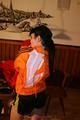 Jill wearing a sexy black nylon shorts and a orange rain jacket while dressing her up (Pics)