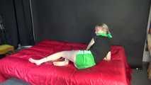 *** Sexy MIA wearing a green shiny nylon shorts and a black top ties and gagges herself with cuffs and a clothgag on a bed (Video)***