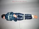One of our archive girls tied and gagged in shiny nylon rainwear