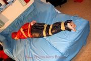 one of our archive girls tied and gagged in shiny nylon rainwear