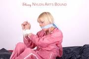 Pia tied and gagged in a beautiful rose shiny nylon rainsuit in bed (Pics)
